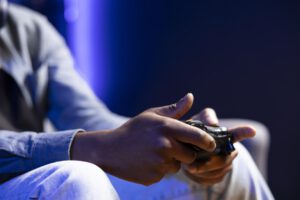 https://www.vecteezy.com/photo/49711374-gamer-in-rgb-lit-home-gaming-with-gamepad-enjoying-himself-close-up-shot-of-man-sitting-on-sofa-in-neon-illuminated-living-room-playing-videogames-on-console-using-controller